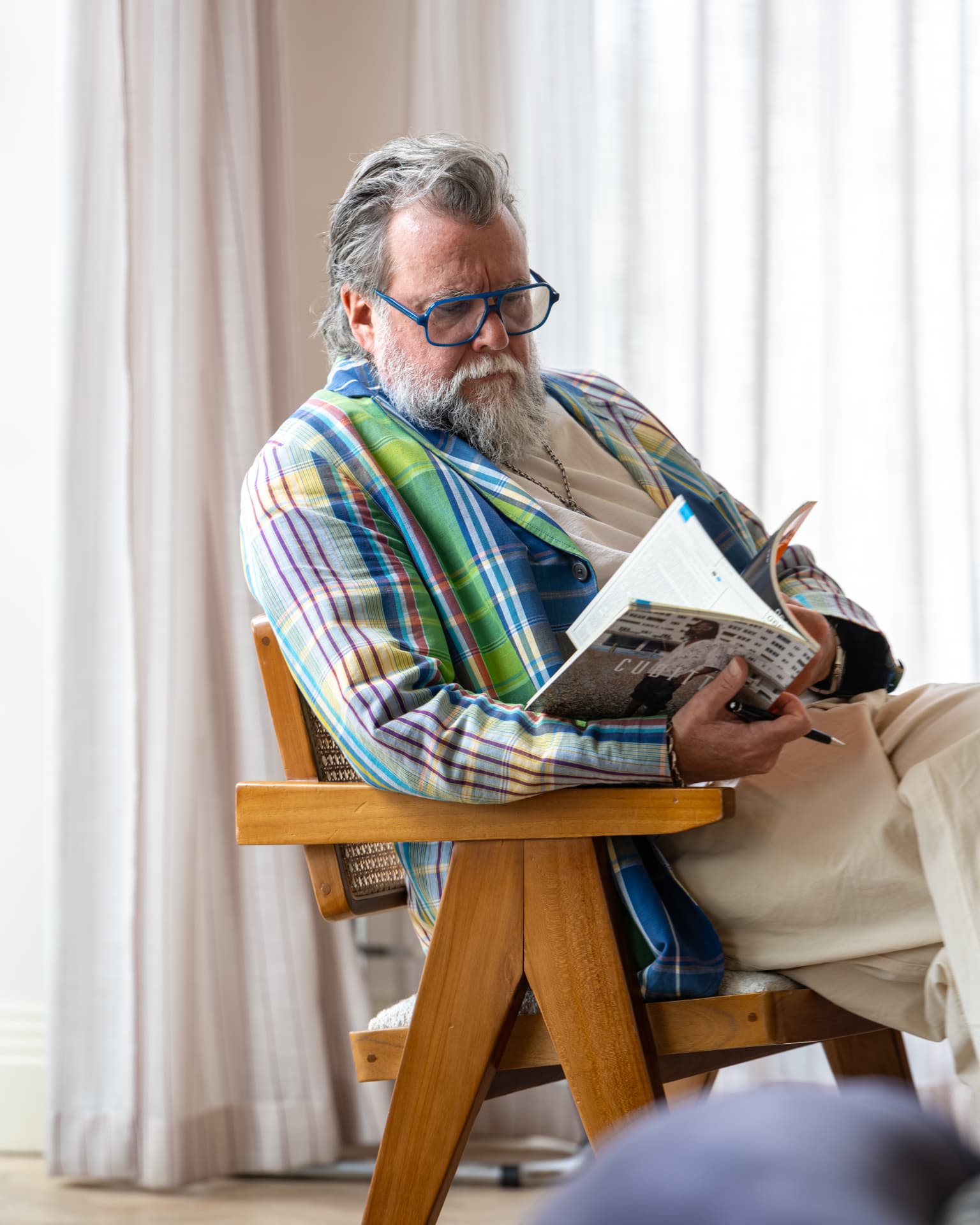 A guest reading the magazine in an armchair