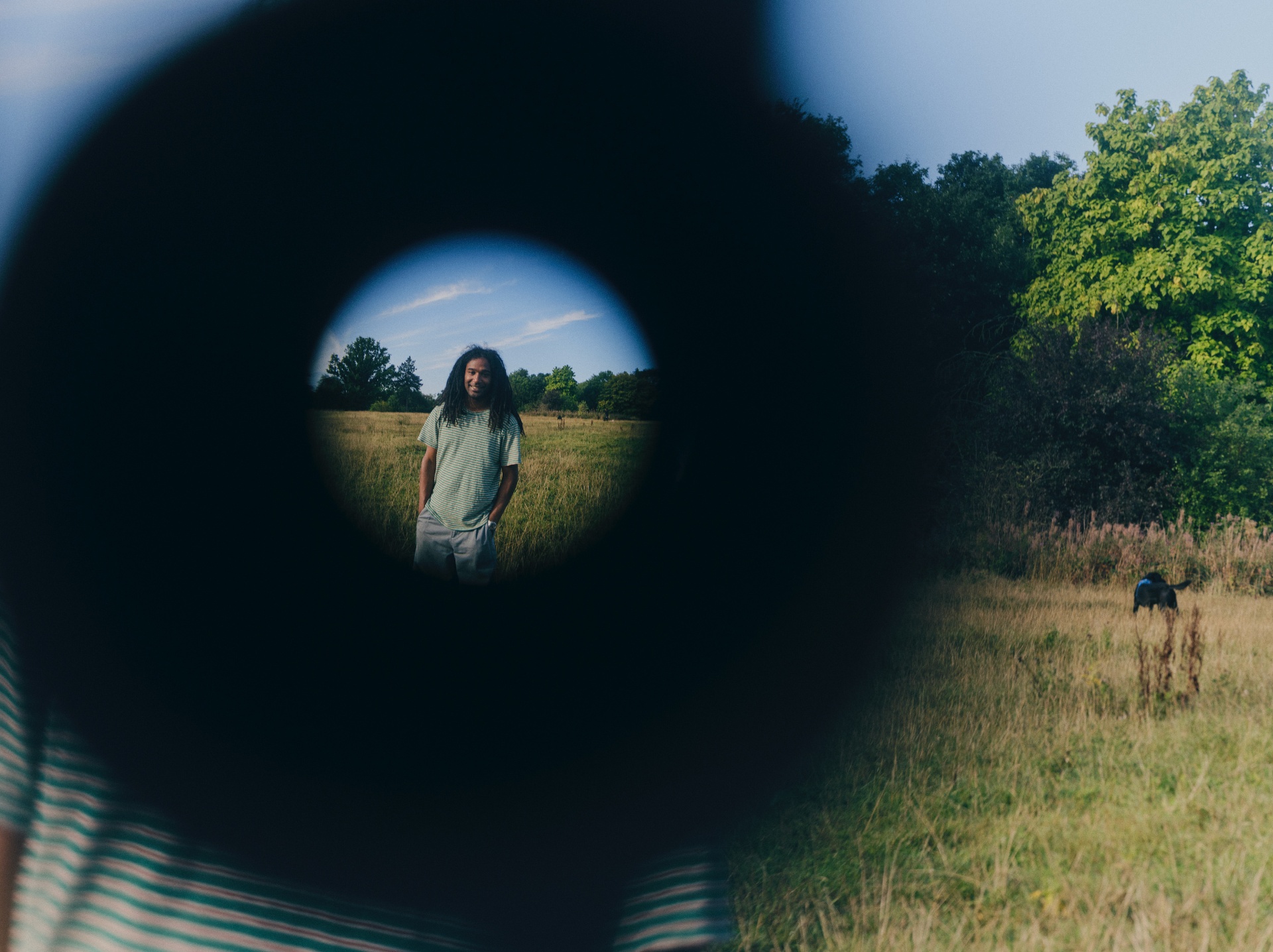 Nadeem Perera looking through binoculars