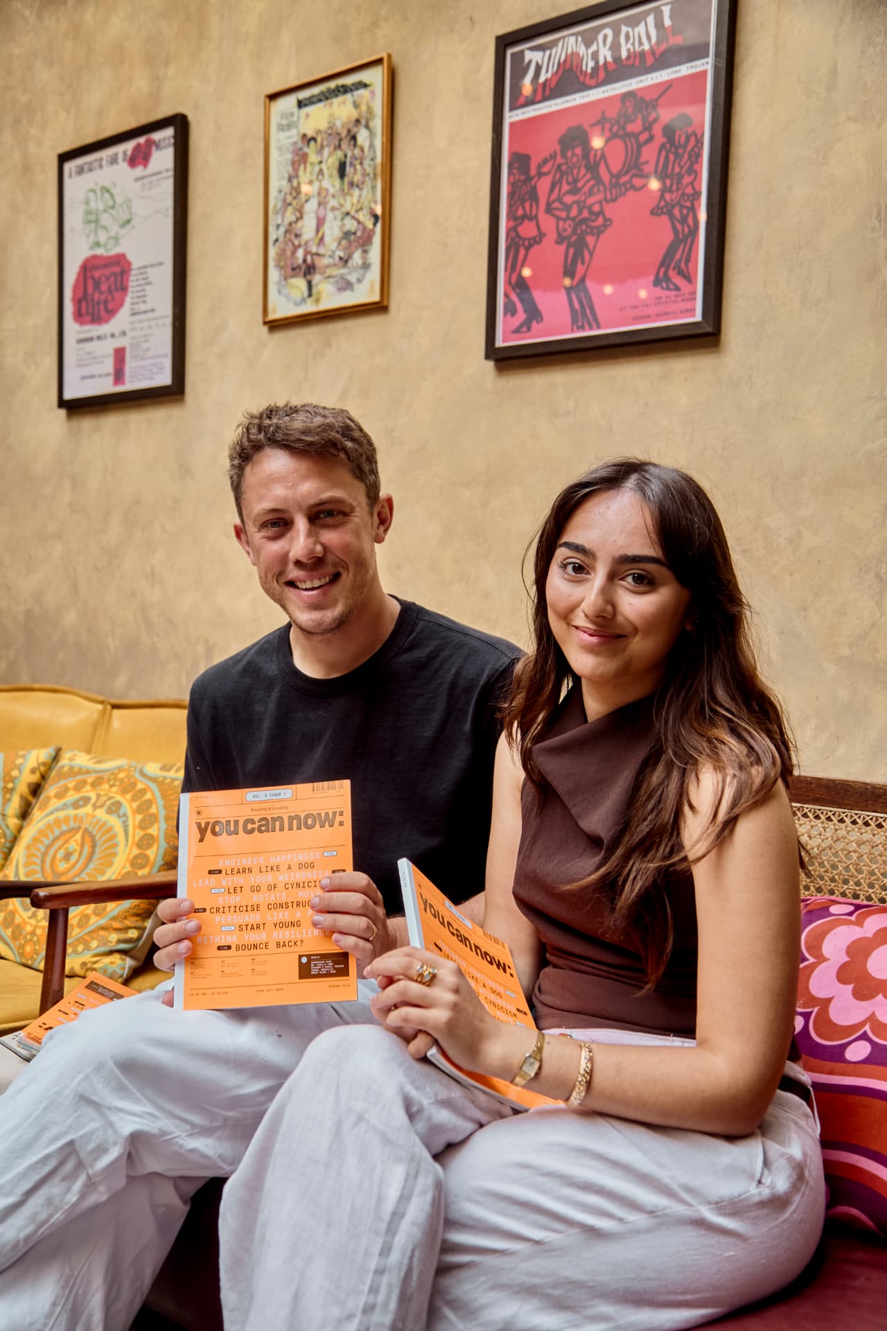 Two guests sitting together holding copies of You Can Now magazine