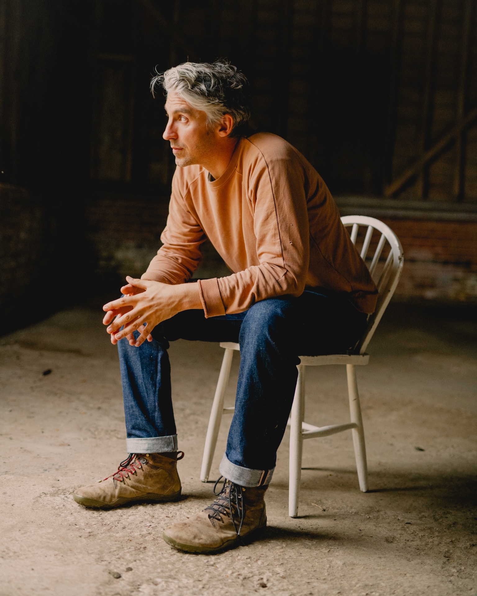 Edd Lees, co-founder of Wildfarmed, seated in a barn