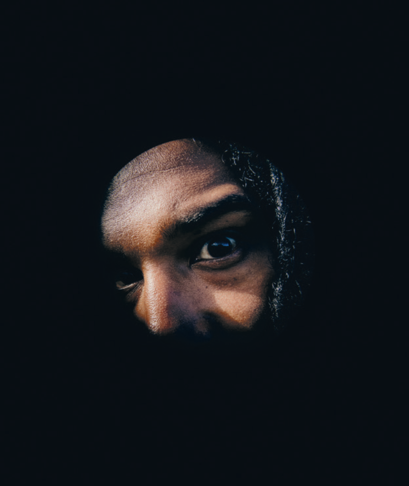 Portrait of Nadeem's eyes emerging from darkness