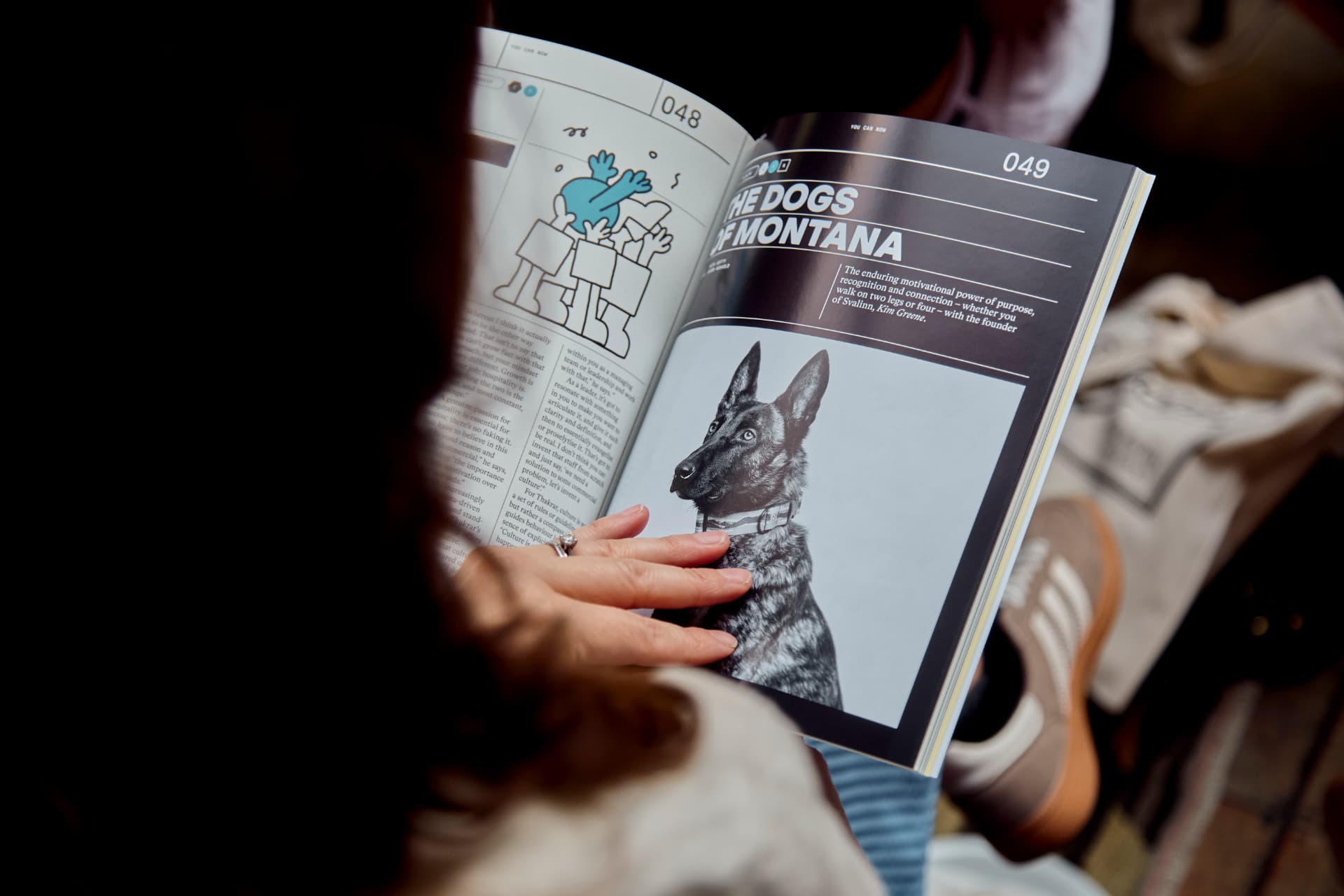A guest reading a feature spread from You Can Now magazine