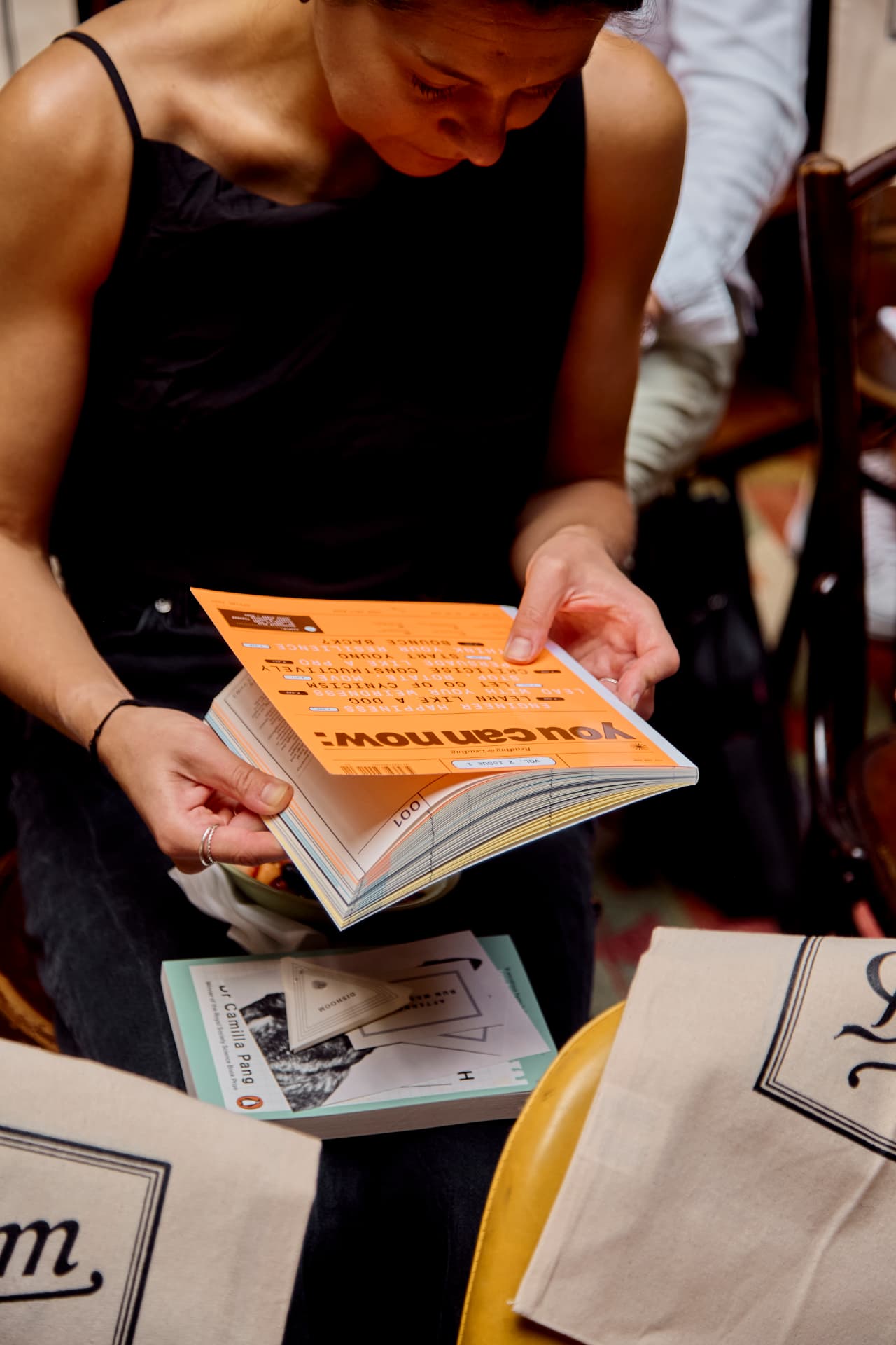 A guest leafing through the magazine at a table