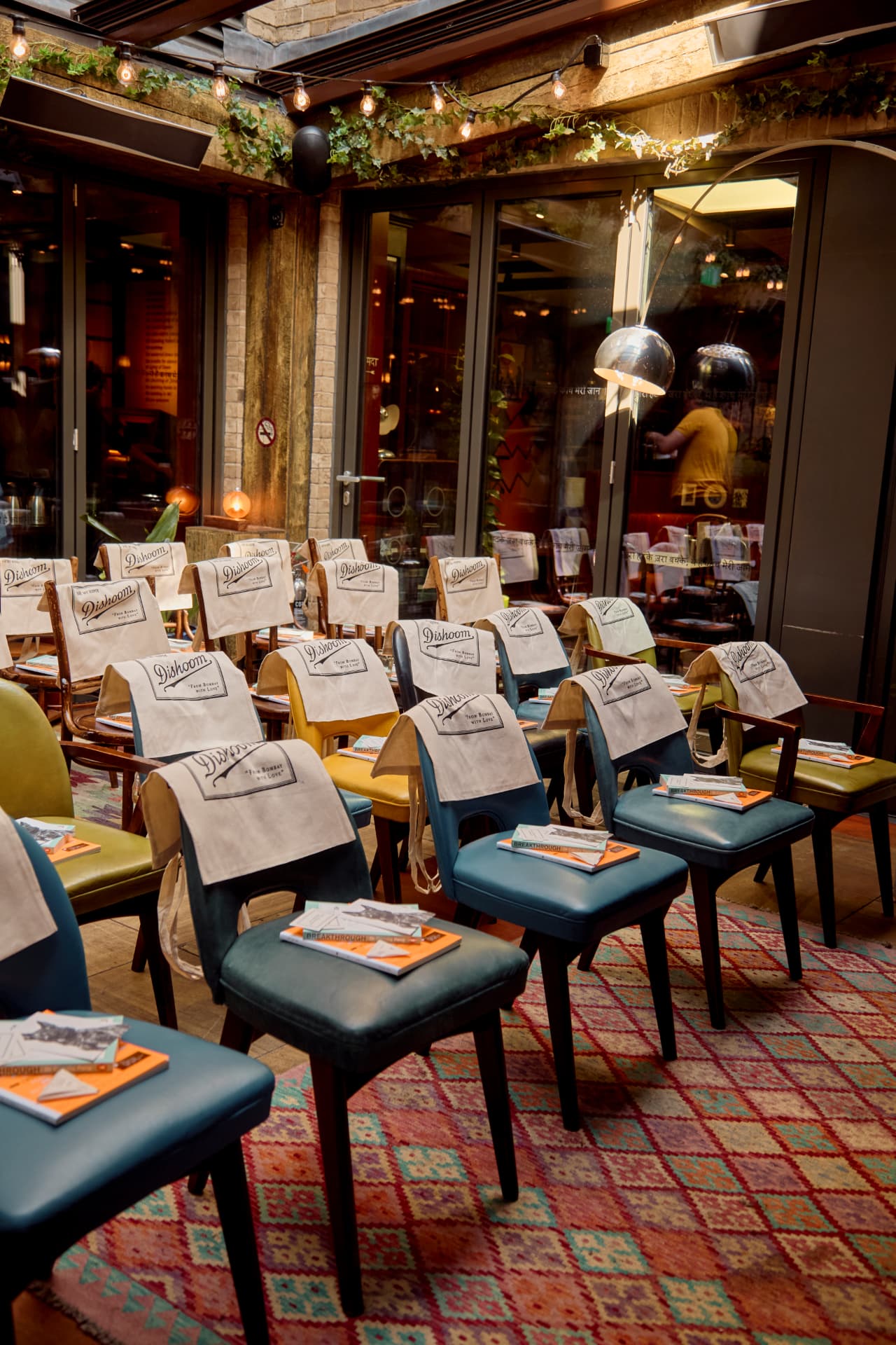 Chairs set out with magazines and tote bags before a breakfast event at Dishoom