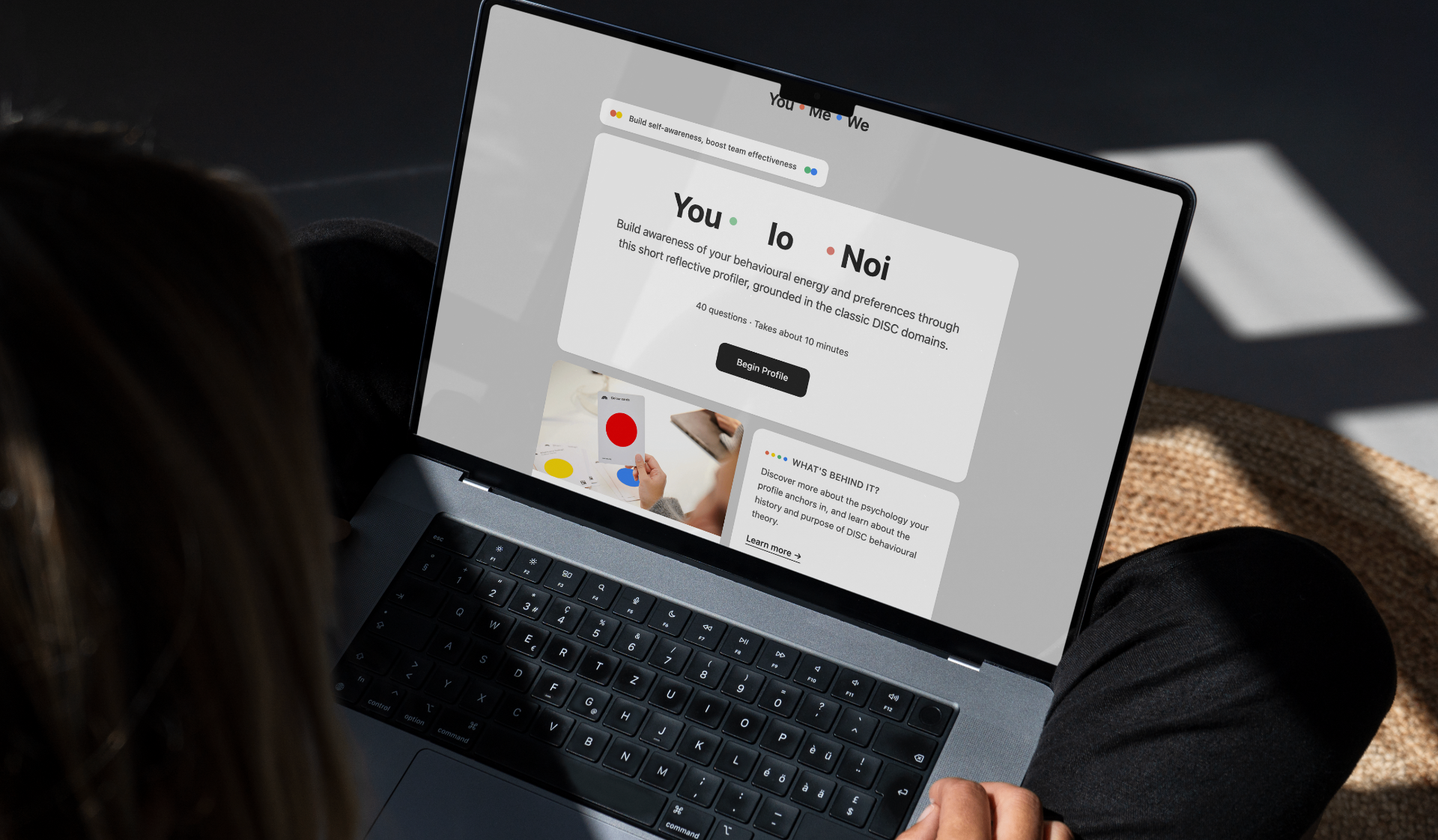 A laptop screen showing the You Me We DISC profiler